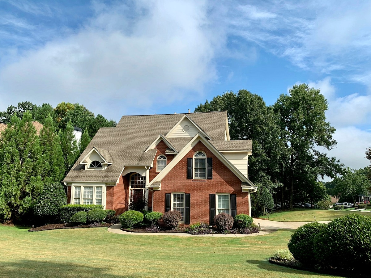 Red-brick two-storey detached family home in London, Ontario illustrating standard charge versus collateral charge mortgage renewal and lender-paid switch programs